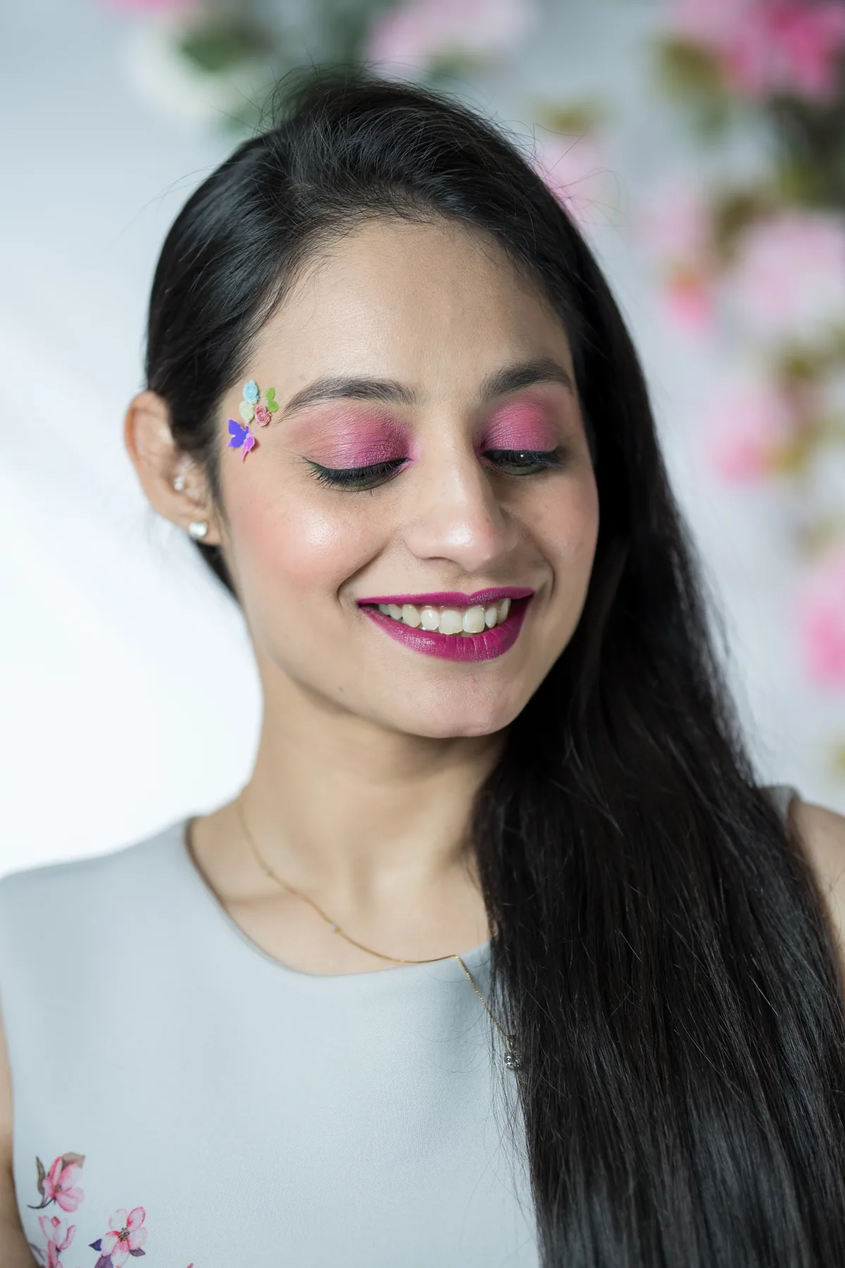 Cherry blossom inspired self makeup portrait on Gurvani with pink eye makeup, floral accents, and a soft glam finish