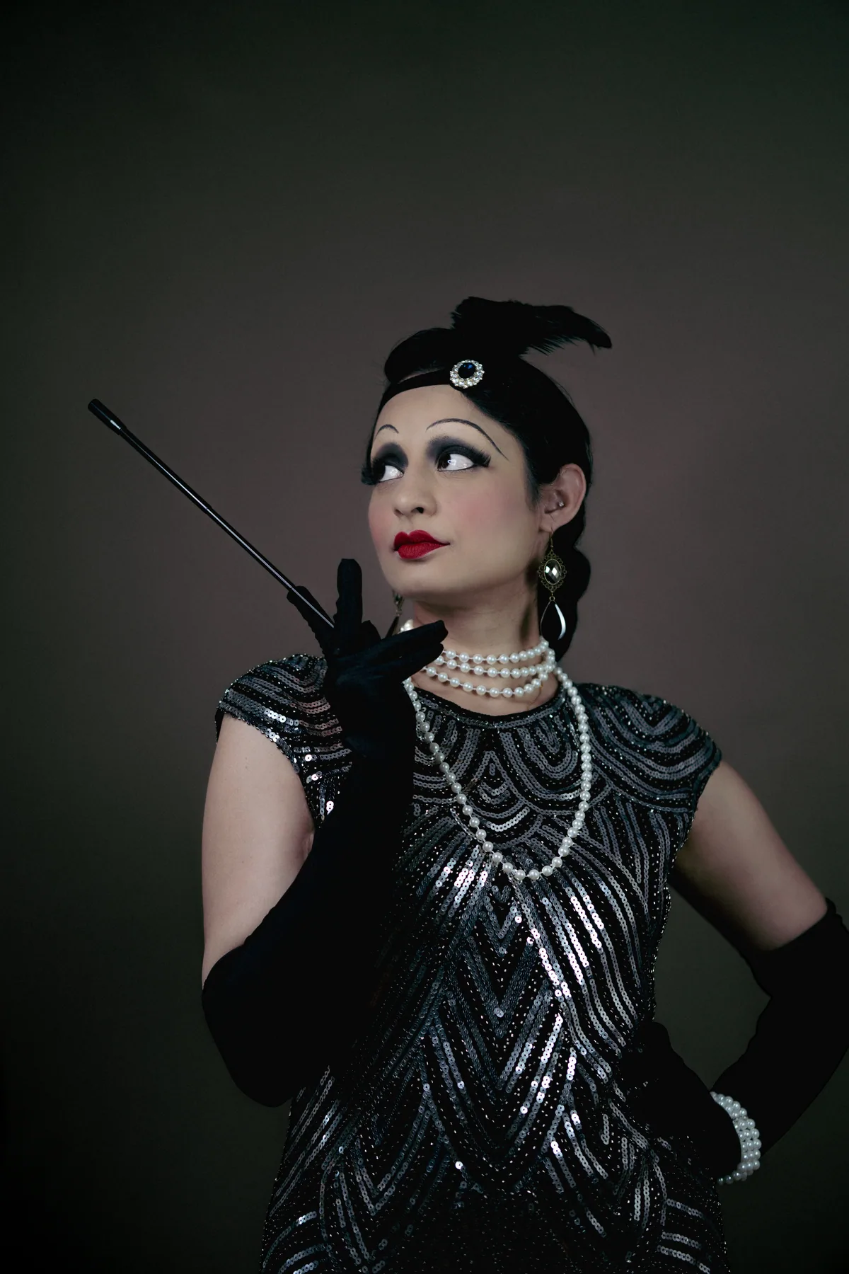 Vintage theatre inspired portrait with sculpted glam makeup, pearl styling, dramatic liner, and an old Hollywood mood